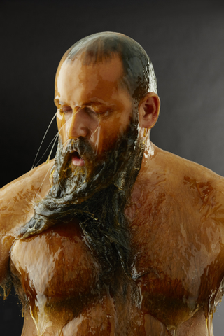 Illustration for article titled Amazing photos of naked people completely covered in honey (NSFW)